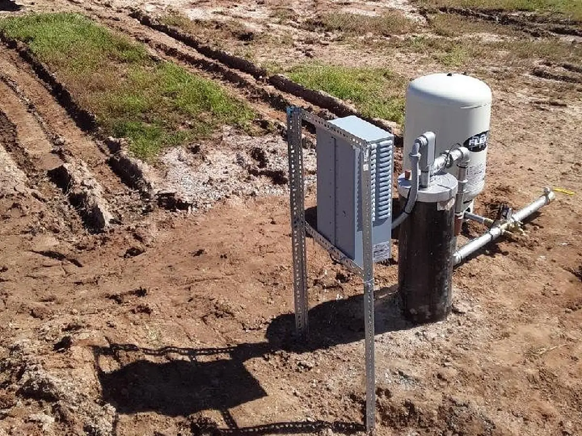 A finished wellhead, pressure tank and panel at a home