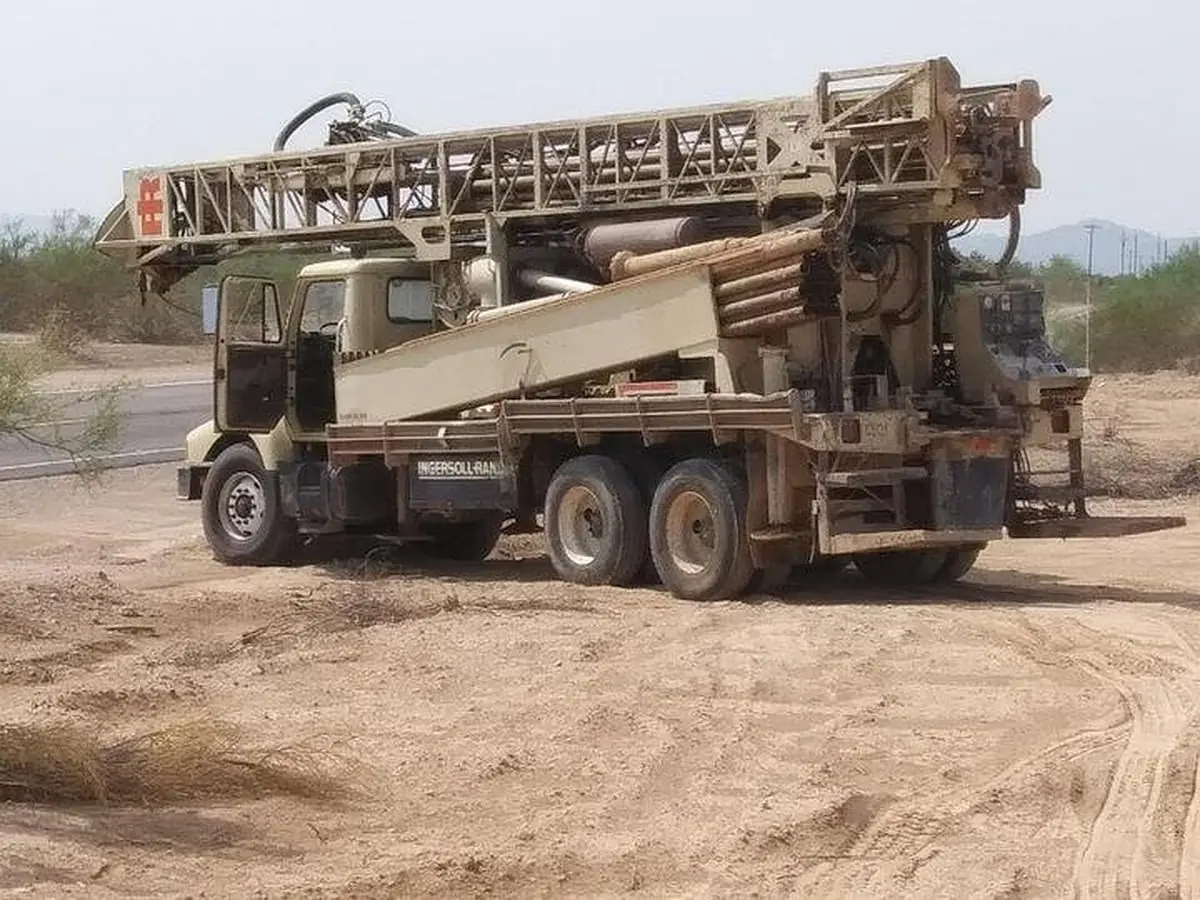 Universal Drilling's drill rig parked on an open Arizona job site
